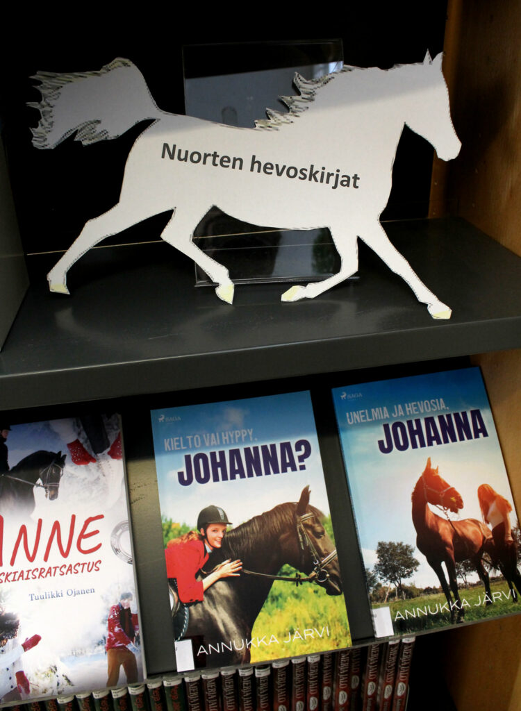 Valkoinen paperihevonen, jossa teksti nuorten hevoskirjat. Alla kirjoja.